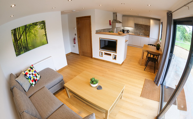 Lounge and kitchen area of luxury self catering accommodation at Blackthorn Fishery